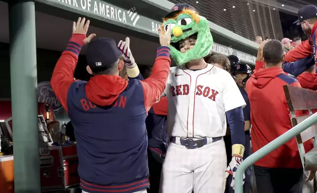 Boston Red Sox's Triston Casas, right, celebrates his three-run home run during the seventh inning of a baseball game against the Seattle Mariners, Tuesday, April 22, 2025, in Boston. (AP Photo/Mark Stockwell)