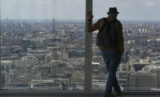 A visitors looks from the Lookout viewing point, in London, Wednesday, April 9, 2025. (AP Photo/Alberto Pezzali)
