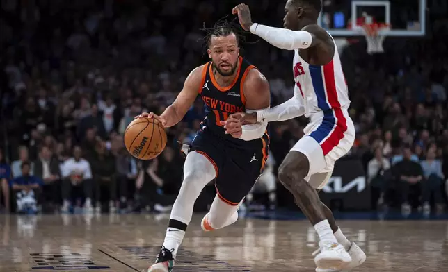 New York Knicks guard Jalen Brunson (11) drives toward the basket to make a 2-pointer at the end of Game 2 of an NBA basketball first-round playoff series against the Detroit Pistons, Monday, April 21, 2025, in New York. (AP Photo/Angelina Katsanis)