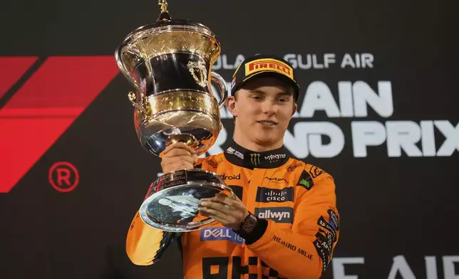 McLaren driver Oscar Piastri of Australia holds trophy after winning the the Formula One Bahrain Grand Prix, in Sakhir, Sunday, April 13, 2025. (AP Photo/Darko Bandic)
