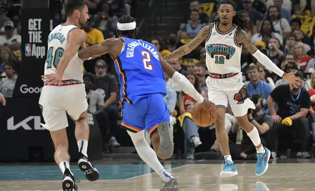 Oklahoma City Thunder guard Shai Gilgeous-Alexander (2) brings the ball upcourt against Memphis Grizzlies guards John Konchar (46) and Ja Morant (12) in the first half of Game 3 of an NBA first-round playoff series Thursday, April 24, 2025, in Memphis, Tenn. (AP Photo/Brandon Dill)