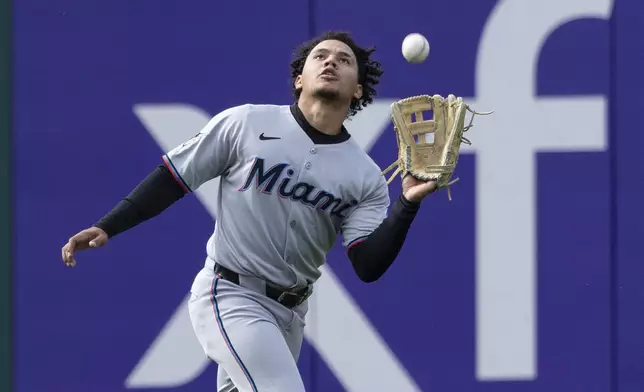 Miami Marlins left fielder Javier Sanoja (46) catches a fly from Philadelphia Phillies' Alec Bohm in the 10th inning of a baseball game, Sunday, April 20, 2025, in Philadelphia. (AP Photo/Laurence Kesterson)