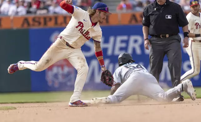 Miami Marlins' Dane Myers (54) is safe at second before Philadelphia Phillies second baseman Bryson Stott can make the tag in the 10th inning of a baseball game, Sunday, April 20, 2025, in Philadelphia. (AP Photo/Laurence Kesterson)