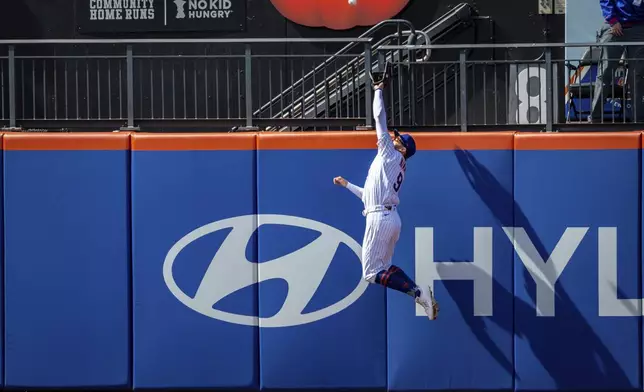 New York Mets' Brandon Nimmo (9) catches St. Louis Cardinals' Jordan Walker (18) ball, resulting in Walker flying out, during the sixth inning of a baseball game, Sunday, April 20, 2025, in New York. (AP Photo/Angelina Katsanis)