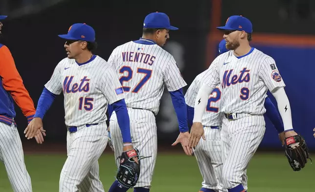 New York Mets' Tyrone Taylor (15) celebrates with teammates Mark Vientos (27), Brandon Nimmo (9) and Luisangel Acuña (2) after a baseball game against the St. Louis Cardinals Thursday, April 17, 2025, in New York. (AP Photo/Frank Franklin II)
