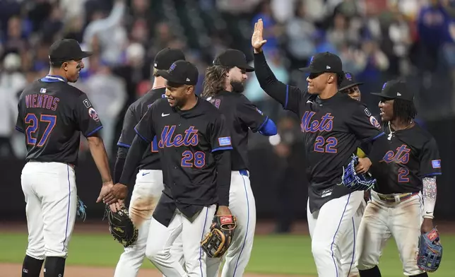 New York Mets' Mark Vientos (27), José Azocar (28), Juan Soto (22) and Luisangel Acuña (2) celebrates with teammates after a baseball game against the Philadelphia Phillies Tuesday, April 22, 2025, in New York. (AP Photo/Frank Franklin II)