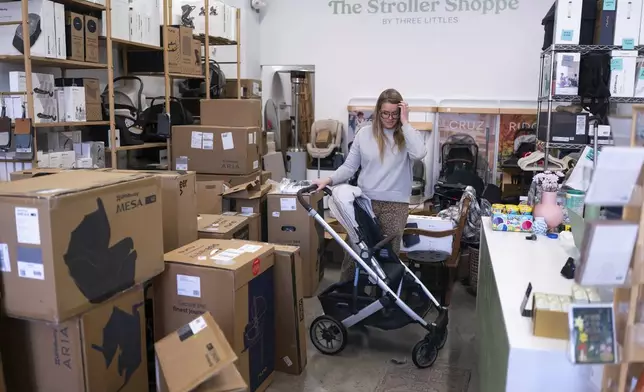 Elizabeth Mahon, owner of baby store Three Littles, unpacks strollers and other inventory ordered by customers ahead of tariff-driven price increases at her Union Market location in Washington, on Wednesday, April 16, 2025. (AP Photo/Nathan Howard)