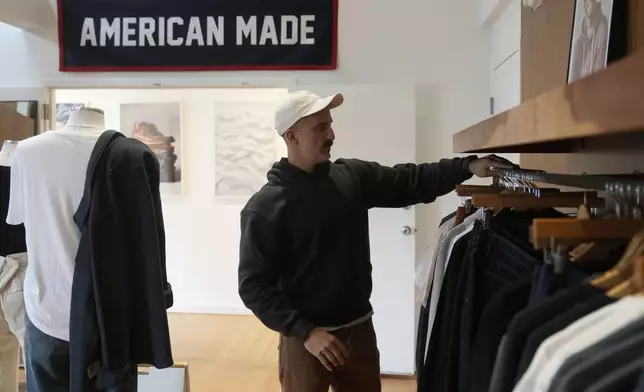 Javid Moghaddasnia, Director of Customer Engagement, discusses American Giant clothing while being interviewed at the company's showroom in San Francisco, Thursday, April 17, 2025. (AP Photo/Jeff Chiu)