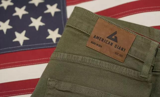 An American Giant logo tag is shown on pants at the company's showroom in San Francisco, Thursday, April 17, 2025. (AP Photo/Jeff Chiu)