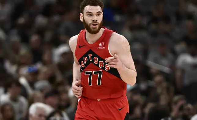 Toronto Raptors forward Jamison Battle celebrates a 3-point basket during the first half of an NBA basketball game against the San Antonio Spurs, Sunday, April 13, 2025, in San Antonio. (AP Photo/Darren Abate)