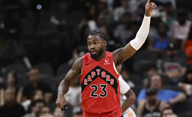 Toronto Raptors guard Jamal Shead celebrates a basket during the first half of an NBA basketball game against the San Antonio Spurs, Sunday, April 13, 2025, in San Antonio. (AP Photo/Darren Abate)