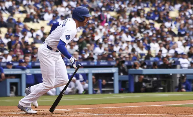 Los Angeles Dodgers' Freddie Freeman drops his bat after hitting an RBI single during the first inning of a baseball game against the Pittsburgh Pirates in Los Angeles, Sunday, April 27, 2025. (AP Photo/Jessie Alcheh)
