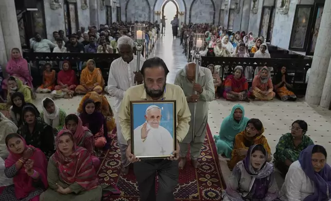 Christians attend prayer services for the late Pope Francis at St. Anthony Church in Lahore, Pakistan, Tuesday, April 22, 2025. (AP Photo/K.M. Chaudary)