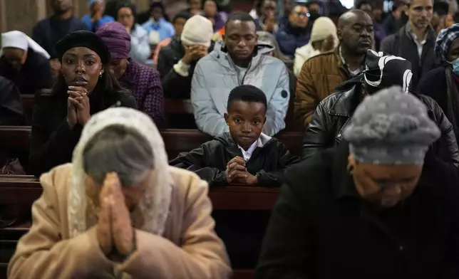 Faithful pray during a Pope Francis Memorial Mass, at the Cathedral of Christ the King, Johannesburg, South Africa, Wednesday, April 23, 2025. (AP Photo/Themba Hadebe)