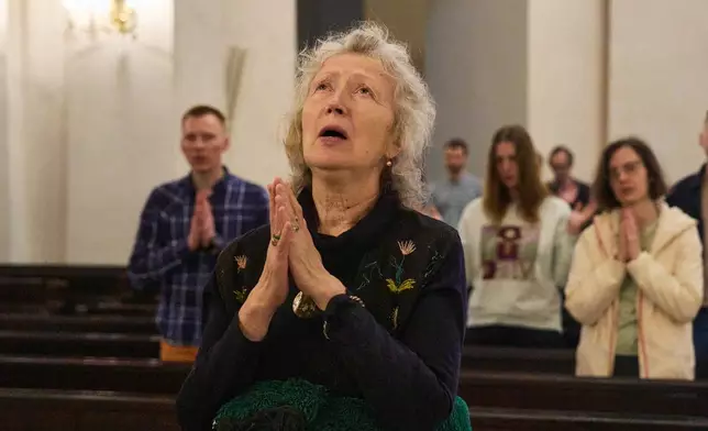 Faithful pray during a service for the late Pope Francis at St. Alexander's Rome Catholic Cathedral in Kyiv Ukraine, Tuesday, April 22, 2025. (AP Photo/Efrem Lukatsky)