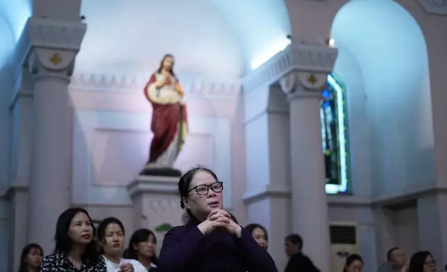 Faithful pray during a mass honoring Pope Francis at the Cua Bac Parish Church in Hanoi, Vietnam on April 23, 2025. (AP Photo/Hau Dinh)