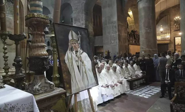 Clergy take part in a Mass led by Latin Patriarch Pierbattista Pizzaballa, the top Catholic clergyman in the Holy Land, in remembrance of Pope Francis at the Church of the Holy Sepulcher, the site where according to tradition Jesus was crucified and buried, in the Old City of Jerusalem, Wednesday, April 23, 2025. (AP Photo/Mahmoud Illean)