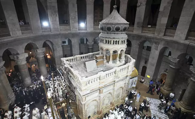 Clergy and worshippers take part in a Mass led by Latin Patriarch Pierbattista Pizzaballa, the top Catholic clergyman in the Holy Land, in remembrance of Pope Francis at the Church of the Holy Sepulcher, the site where according to tradition Jesus was crucified and buried, in the Old City of Jerusalem, Wednesday, April 23, 2025. (AP Photo/Mahmoud Illean)