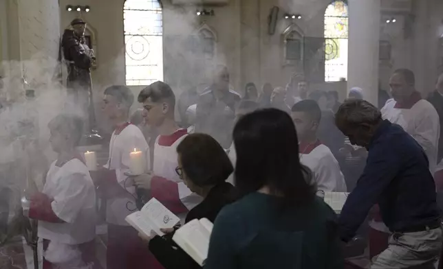Christian Palestinians attend a special prayer for the late Pope Francis after the news of his death at age 88, at the Holy Family Church in the Old City of Gaza, Gaza City, Monday, April 21, 2025. (AP Photo/Jehad Alshrafi)