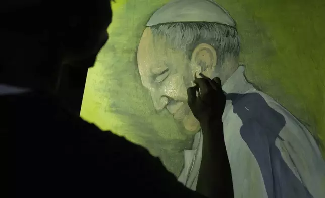 Graffiti artist Alexander Ikawah, paints Pope Francis on a canvas in Nairobi, Kenya Monday, April 21, 2025. (AP Photo/Brian Inganga)