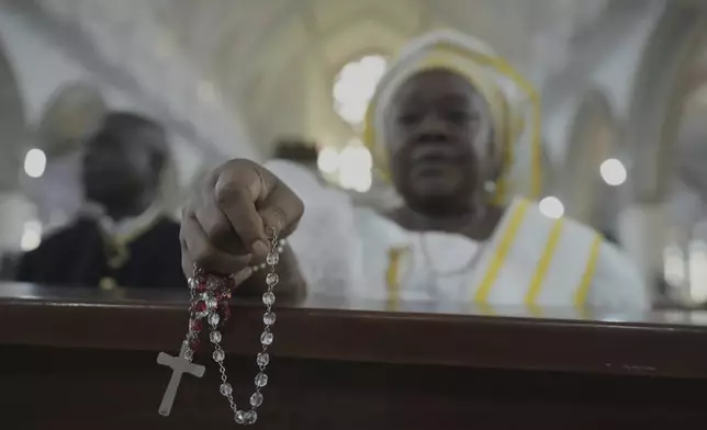 A parishioner prays during a special mass organised in honour of the late Pope Francis at the Holy Cross Cathedral Church in Lagos, Nigeria, Wednesday, April 23, 2025, (AP Photo/Sunday Alamba)