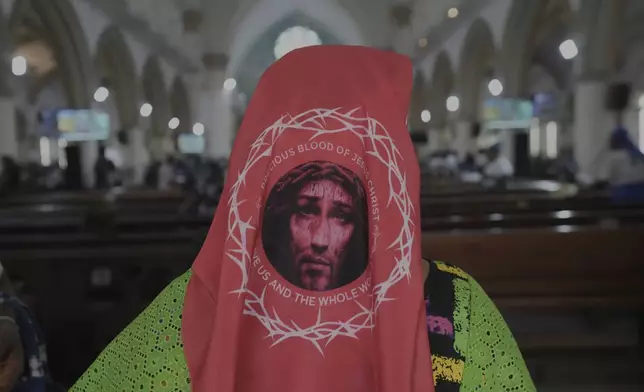 A parishioner prays during a special mass organised in honour of the late Pope Francis at the Holy Cross Cathedral Church in Lagos, Nigeria, Wednesday, April 23, 2025, (AP Photo/Sunday Alamba)
