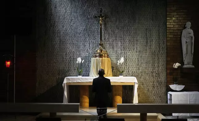A Catholic man prays after the Pope Francis Memorial Mass, at the Cathedral of Christ the King, Johannesburg, South Africa, Wednesday, April 23, 2025. (AP Photo/Themba Hadebe)