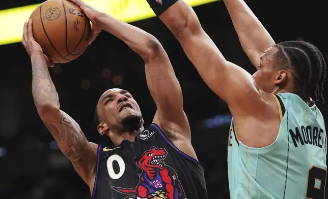 Toronto Raptors' A.J. Lawson (0) shoots over Charlotte Hornets' Wendell Moore Jr. (9) during second half NBA basketball action in Toronto on Wednesday, April 9, 2025. (Frank Gunn/The Canadian Press via AP)