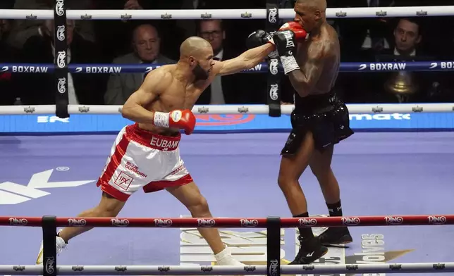 Chris Eubank Jr., left, lands a punch on Conor Benn during their middleweight bout at Tottenham Hotspur Stadium, London, Saturday, April 26, 2025. (Bradley Collyer/PA via AP)