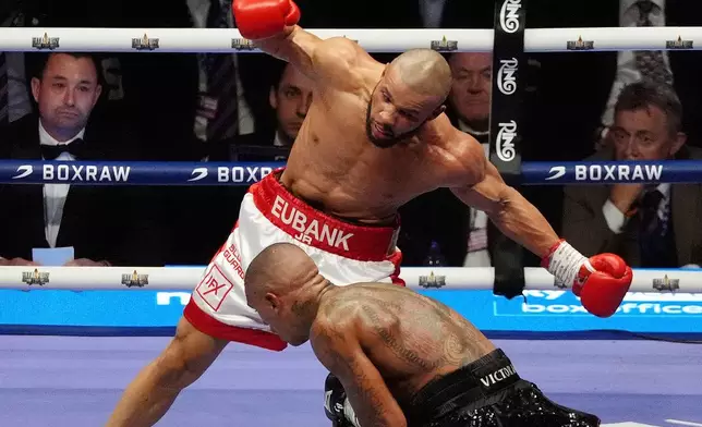 Chris Eubank Jr., top, and Conor Benn fight during their middleweight bout at Tottenham Hotspur Stadium, London, Saturday, April 26, 2025. (Bradley Collyer/PA via AP)