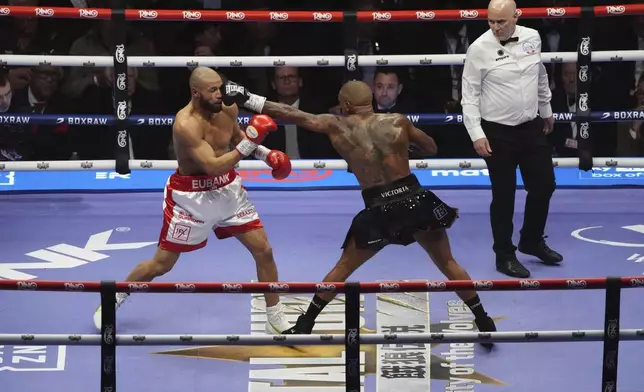 Conor Benn, right, lands a punch on Chris Eubank Jr. during their middleweight bout at Tottenham Hotspur Stadium, London, Saturday, April 26, 2025. (Bradley Collyer/PA via AP)