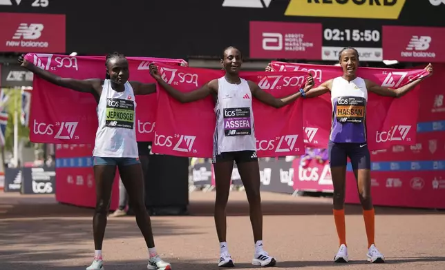 Tigst Assefa of Ethiopia, centre, winner of the women's race with Joyciline Jepkosgei, of Kenya, left, placed second and Sifan Hassan of the Netherlands, placed third, pose for the media after finishing at the London Marathon, Sunday, April 27, 2025. (AP Photo/Alberto Pezzali)