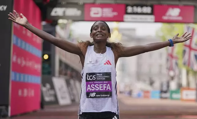 Tigst Assefa of Ethiopia celebrates after winning the women's race at the London Marathon, Sunday, April 27, 2025. (AP Photo/Alberto Pezzali)