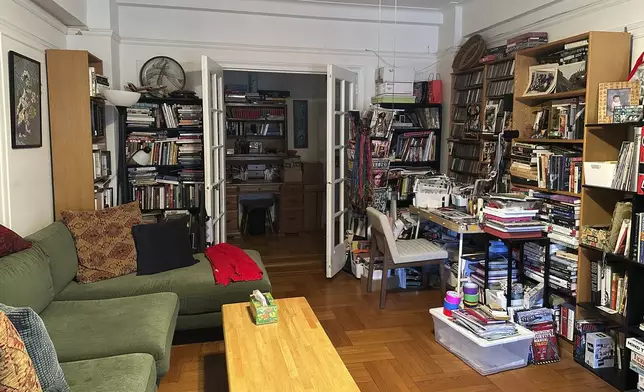 A cluttered living room appears in New York on Tuesday, April 8, 2025. (AP Photo/Leanne Italie)