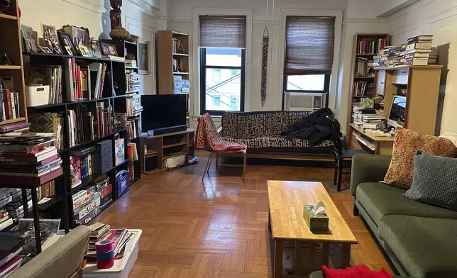 A cluttered living room appears in New York on Tuesday, April 8, 2025. (AP Photo/Leanne Italie)