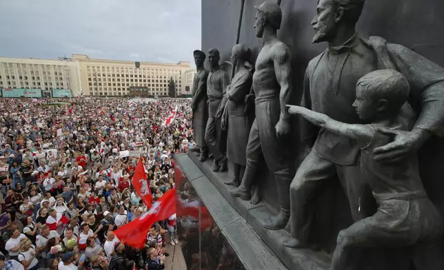 FILE - Belarusian opposition supporters gather for a protest in front of the government building at Independence Square in Minsk, Belarus, with a Soviet-era monument in the foreground, on Aug. 18, 2020. (AP Photo/Dmitri Lovetsky, File)