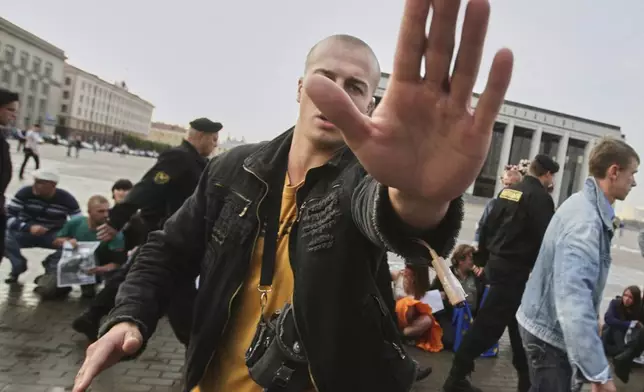 FILE - A plainclothes police officer obstructs a photographer working at an opposition rally in Minsk, Belarus, on Sept. 16, 2009.(AP Photo, File)