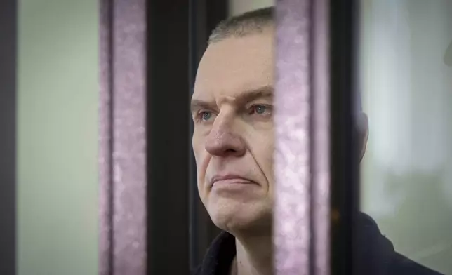 FILE - Journalist Andrzej Poczobut stands in a defendants' cage in court in Grodno, Belarus, on Jan. 16, 2023. (Leonid Shcheglov/Pool via AP, File)