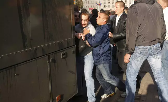 FILE - Belarus plainclothes policemen detain political analyst Ihar Iliyash during a rally in Minsk, Belarus, on July 3, 2011. (AP Photo, File)