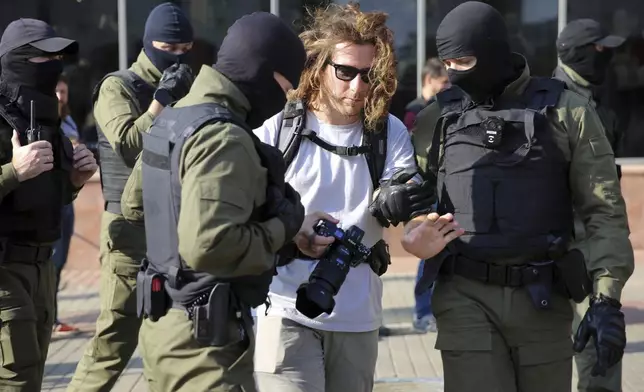 FILE - Police detain a photojournalist at an opposition rally protesting presidential election results in Minsk, Belarus, on Sept. 26, 2020. (AP Photo, File)