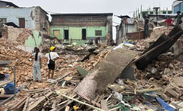 People clean debris from damaged buildings in the aftermath of an earthquake on March 28, in Naypyitaw, Myanmar, Monday, April 7, 2025. (AP Photo)