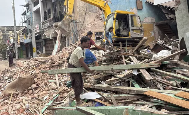 People clean debris from damaged buildings in the aftermath of an earthquake on March 28, in Naypyitaw, Myanmar, Monday, April 7, 2025. (AP Photo)