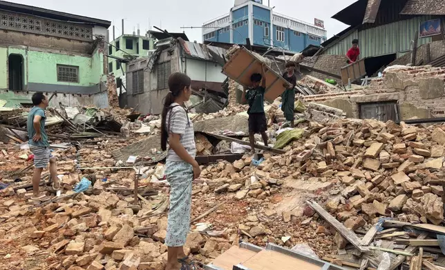 People clean debris from damaged buildings in the aftermath of an earthquake on March 28, in Naypyitaw, Myanmar, Monday, April 7, 2025. (AP Photo)