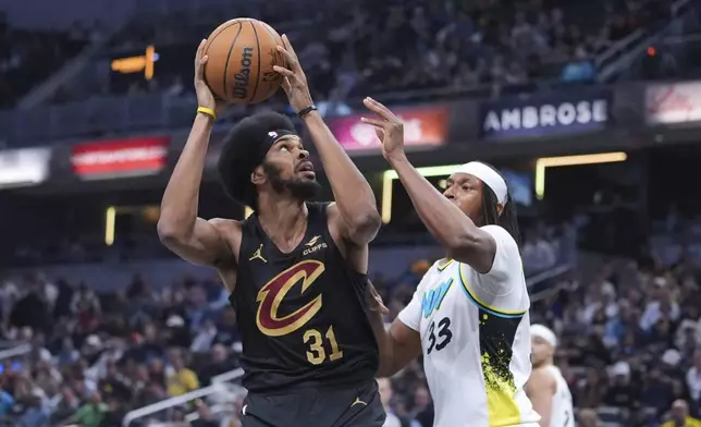 Cleveland Cavaliers center Jarrett Allen (31) shoots over Indiana Pacers center Myles Turner (33) during the first half of an NBA basketball game in Indianapolis, Thursday, April 10, 2025. (AP Photo/Michael Conroy)