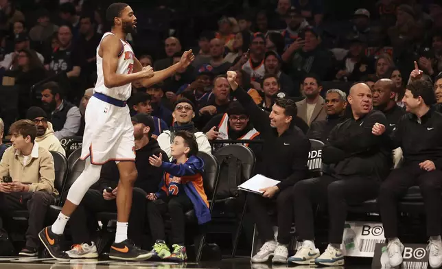 New York Knicks forward Mikal Bridges (25) checks out and returns to the bench during the first half of an NBA basketball game against the Brooklyn Nets, Sunday, April 13, 2025, in New York. (AP Photo/Heather Khalifa)