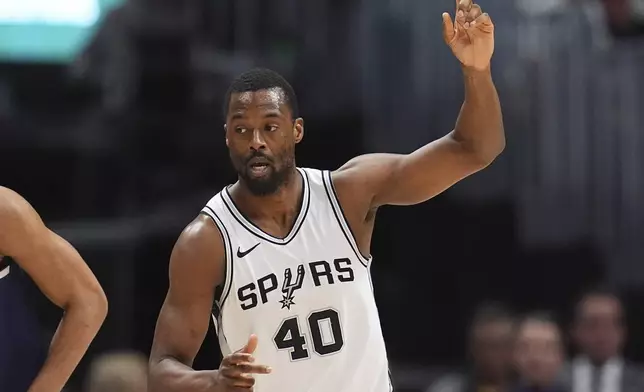 San Antonio Spurs forward Harrison Barnes gestures after hitting a 3-point shot against the Denver Nuggets in the first half of an NBA basketball game Wednesday, April 2, 2025, in Denver. (AP Photo/David Zalubowski)