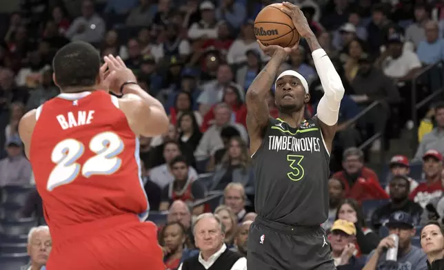 Minnesota Timberwolves forward Jaden McDaniels (3) shoots against Memphis Grizzlies guard Desmond Bane (22) in the first half of an NBA basketball game Thursday, April 10, 2025, in Memphis, Tenn. (AP Photo/Brandon Dill)