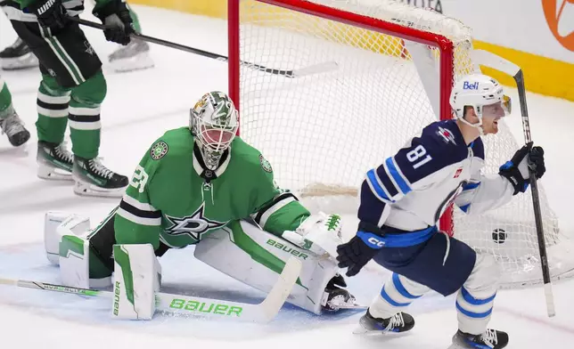 Winnipeg Jets left wing Kyle Connor (81) reacts after scoring a goal on Dallas Stars goaltender Jake Oettinger (29) during the third period of an NHL hockey game Thursday, April 10, 2025, in Dallas. (AP Photo/Julio Cortez)