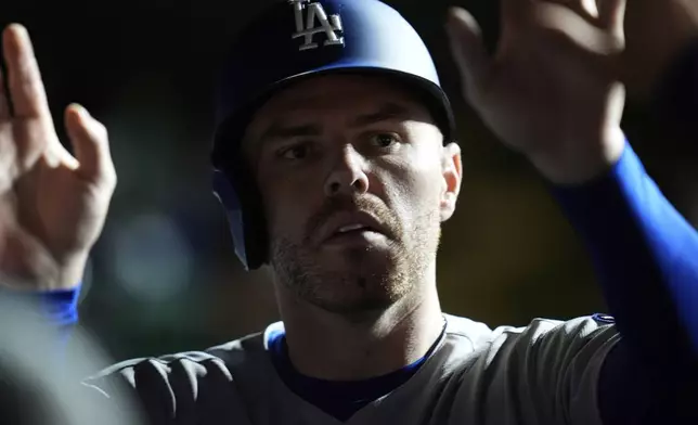 Los Angeles Dodgers' Freddie Freeman (5) celebrates after scoring on a double from Will Smith during the seventh inning of a baseball game against the Chicago Cubs, Tuesday, April 22, 2025, in Chicago. (AP Photo/Erin Hooley)