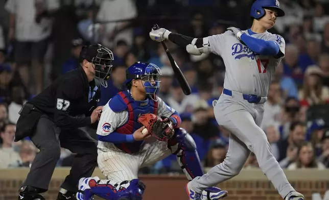 Los Angeles Dodgers designated hitter Shohei Ohtani (17) strikes out during the eighth inning of a baseball game against the Chicago Cubs, Tuesday, April 22, 2025, in Chicago. (AP Photo/Erin Hooley)